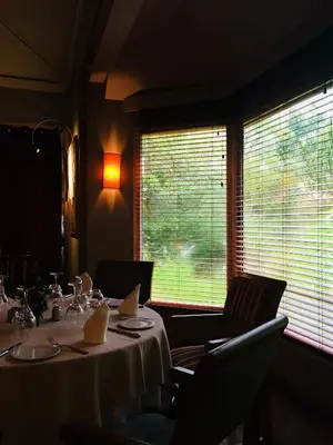 a dining room with a table and chairs and a window at La Villa Mandarine in Rabat