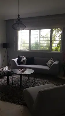 a living room with a couch and a table at Residence les Pins in Rabat