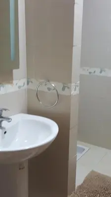 a bathroom with a white sink and a mirror at Residence les Pins in Rabat