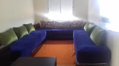a blue couch in a living room with a window at Appartement Tamaris couple mariés in Tamaris