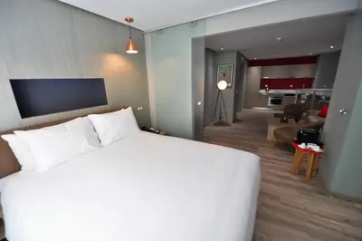 a hotel room with a bed and a living room at Le 22 Appart'Hotel in Casablanca