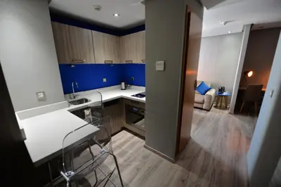 a kitchen with blue walls and white counter tops at Le 22 Appart'Hotel in Casablanca