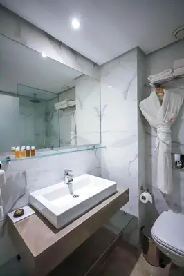 a white bathroom with a sink and a toilet at Gray Boutique Hotel Casablanca in Casablanca