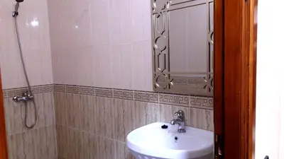 a bathroom with a sink and a mirror at Joudia in Temara
