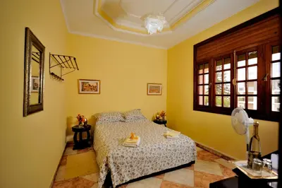 a bedroom with a bed in a room with yellow walls at LHOSTEL à Casablanca in Casablanca