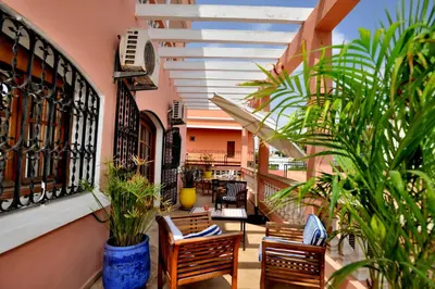a balcony with chairs and plants in a building at LHOSTEL à Casablanca in Casablanca