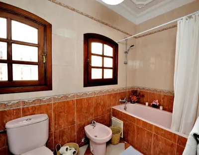 a bathroom with a toilet and a tub and a sink at LHOSTEL à Casablanca in Casablanca