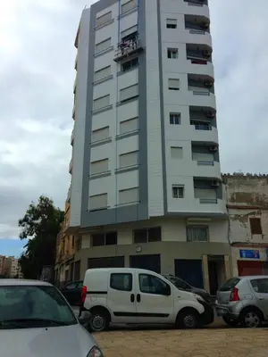a white van parked in front of a tall building at Res Mario 3 Lovely Apartment With Balcony & Sea View Free Wifi in Casablanca