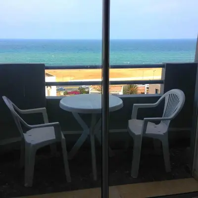 a table and chairs on a balcony with the ocean at Res Mario 3 Lovely Apartment With Balcony & Sea View Free Wifi in Casablanca