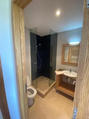 a bathroom with a shower and a toilet and a sink at Résidence Evasion in Bouznika
