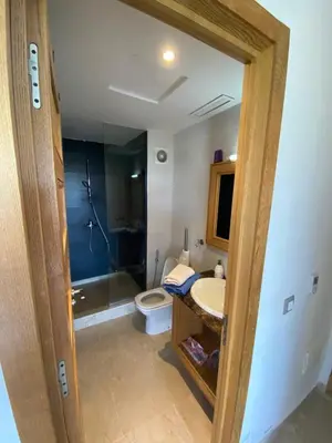 a bathroom with a toilet and a sink and a shower at Résidence Evasion in Bouznika
