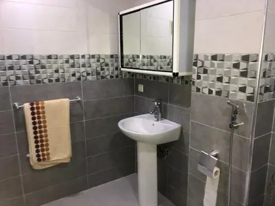 a bathroom with a sink and a mirror at Familly Apartement Agdal Rabat centre in Rabat