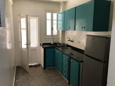 a kitchen with blue cabinets and a sink and a refrigerator at Familly Apartement Agdal Rabat centre in Rabat