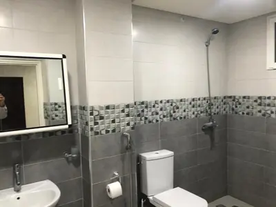 a bathroom with a toilet and a sink and a mirror at Familly Apartement Agdal Rabat centre in Rabat