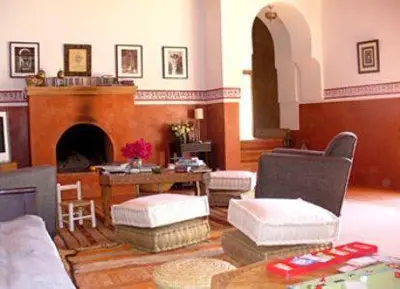 a living room with a couch and a fireplace at Dar Al Manar in El Jadida