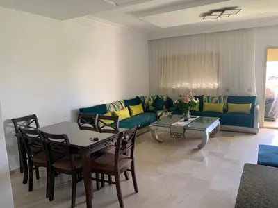a living room with a couch and a table at Savannah Beach D11 in Sidi Rahal