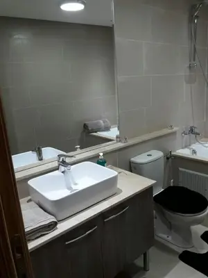 a bathroom with a sink and a toilet and a mirror at Nouaceur Garden Comfort and Serenity Casa Airport in Nouaseur