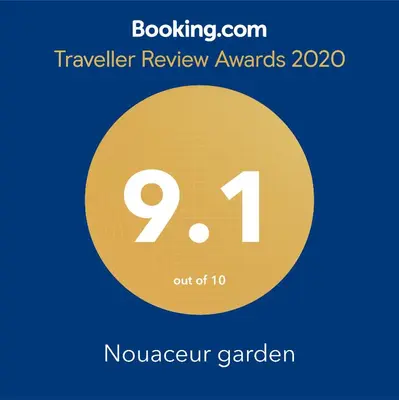 a yellow circle with the number and the text travelling review awards at Nouaceur Garden Comfort and Serenity Casa Airport in Nouaseur