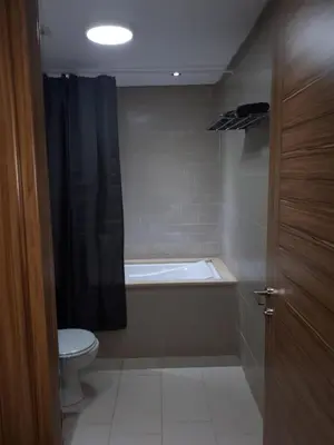 a bathroom with a bath tub and a toilet at Nouaceur Garden Comfort and Serenity Casa Airport in Nouaseur