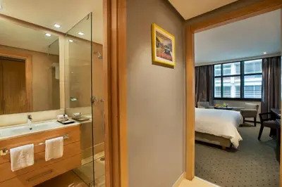 a bathroom with a bed and a sink and a mirror at ODYSSEE Boutique Hotel Casablanca in Casablanca
