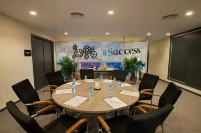 a conference room with a large wooden table and chairs at ODYSSEE Boutique Hotel Casablanca in Casablanca
