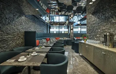 a restaurant with long tables and blue chairs at ODYSSEE Boutique Hotel Casablanca in Casablanca