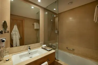 a bathroom with a sink and a shower and a mirror at ODYSSEE Boutique Hotel Casablanca in Casablanca