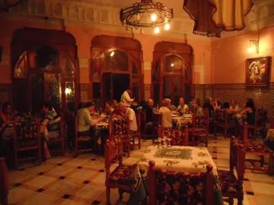 a group of people sitting at tables in a restaurant at Hôtel Transatlantique in Casablanca