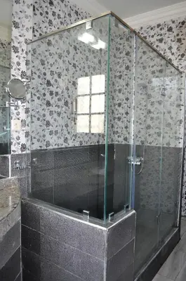 a shower with a glass door in a bathroom at Hôtel Transatlantique in Casablanca