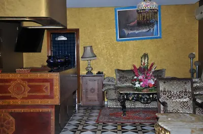 a living room with a couch and a chair at Hôtel Transatlantique in Casablanca
