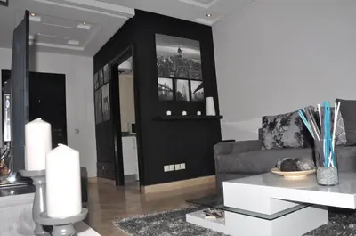 a living room with a couch and a table at Elegant Apartment with Balcony in Val Fleuri, Maarif Casablanca, Perfect for Family & Corporate Stays in Casablanca