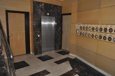 a hallway with a door and a tile floor at Elegant Apartment with Balcony in Val Fleuri, Maarif Casablanca, Perfect for Family & Corporate Stays in Casablanca