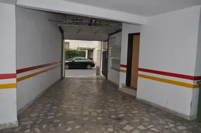 a hallway with a car parked in a building at Elegant Apartment with Balcony in Val Fleuri, Maarif Casablanca, Perfect for Family & Corporate Stays in Casablanca