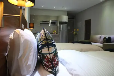 a living room with two pillows on a couch at L'escale Suites Résidence Hôtelière By 7AV HOTELS in Mohammedia