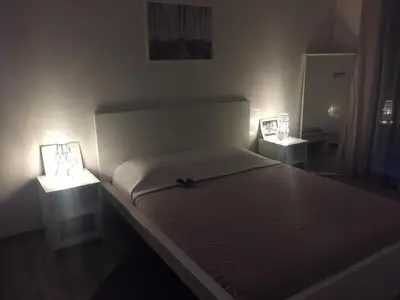 a bedroom with a bed with two lights on it at Appartement Cosy - Corniche plage Mohammedia in Mohammedia