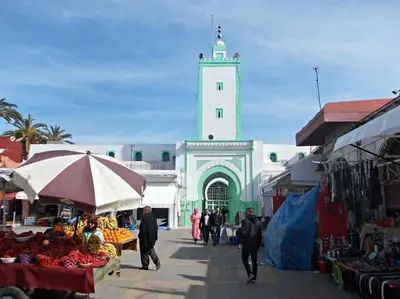 a market with a building with a clock tower at Appartement Cosy - Corniche plage Mohammedia in Mohammedia