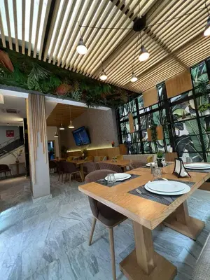 a dining room with a wooden table and chairs at Suite Loc Suite & Spa in Casablanca