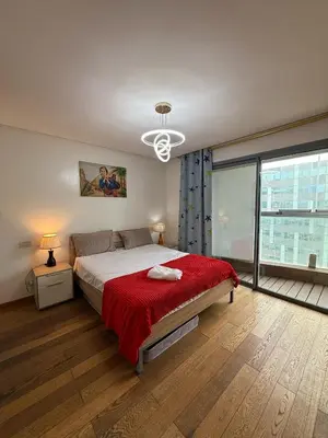 a bedroom with a large bed with a red blanket at Appartement Casa-marina au 10ème étage in Casablanca