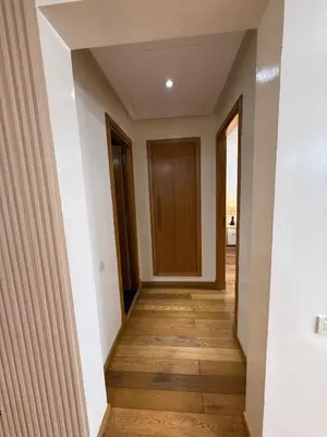a hallway with a door and wooden floor at Appartement Casa-marina au 10ème étage in Casablanca