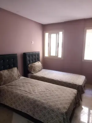 a bedroom with two beds and two windows at Apartment with Terrace in Casablanca
