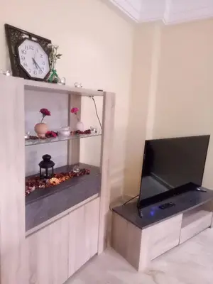 a living room with a tv and a clock at Apartment with Terrace in Casablanca