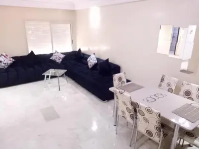 a living room with a black couch and a table at Apartment with Terrace in Casablanca