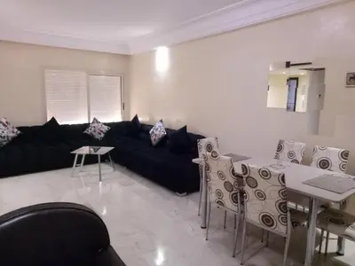 a living room with a black couch and a table at Apartment with Terrace in Casablanca