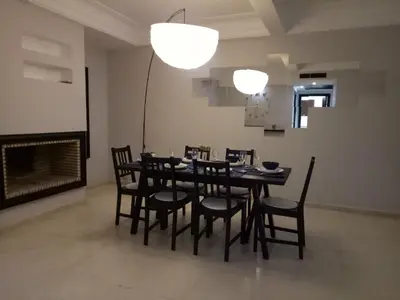 a dining room with a table and chairs and a fireplace at Apartment with Terrace in Casablanca