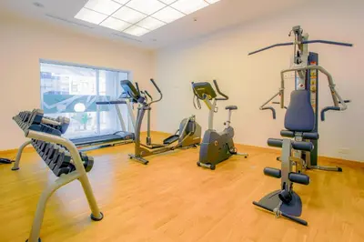 a gym with several treadmills and exercise bikes at Kyriad Residence Casablanca in Casablanca