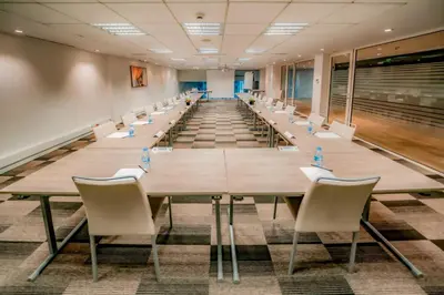a large conference room with a long table and chairs at Kyriad Residence Casablanca in Casablanca