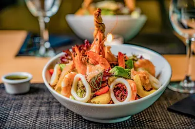 a bowl of seafood salad on a table at Kyriad Residence Casablanca in Casablanca
