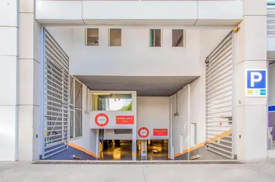 an entrance to a building with a parking sign at Campanile Casablanca Centre Ville in Casablanca