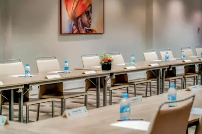 a row of tables and chairs in a room with water bottles at Campanile Casablanca Centre Ville in Casablanca