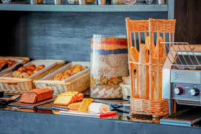 a counter with baskets of bread and other food at Campanile Casablanca Centre Ville in Casablanca